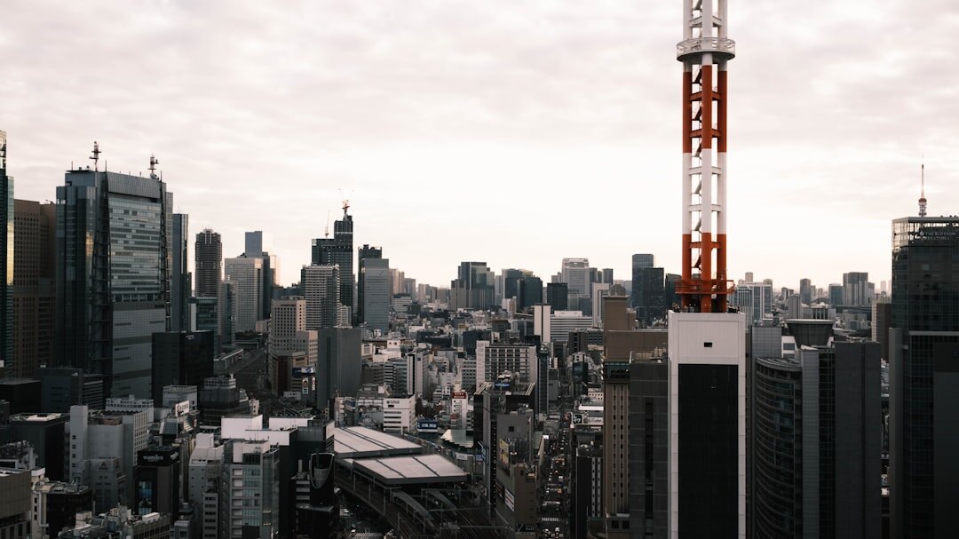 5G wireless network tower with digital speed visualization and cityscape